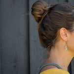 Woman wearing Blue Ua Earrings