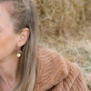 Woman wearing Imuna Earrings - Gold